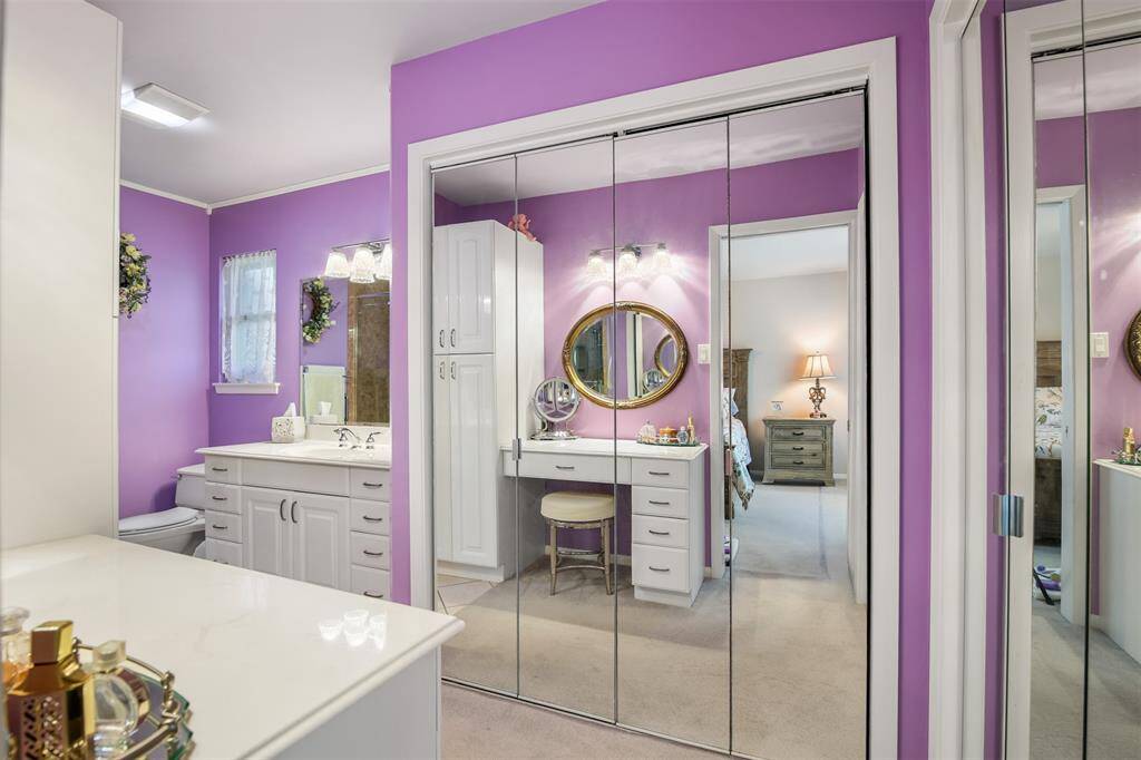 There are double closets in the primary bathroom with mirrored accordion doors.