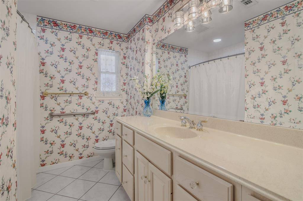 Secondary full bathroom features single sink, tub/shower combo and lots of storage space.