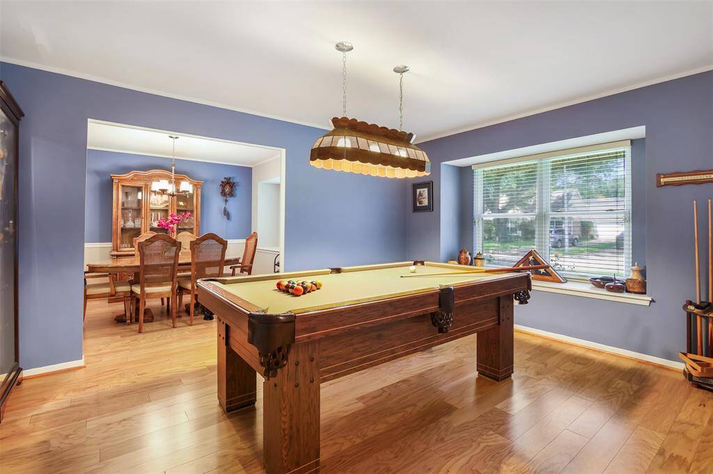 The formal living room is spacious with engineered wood floors, crown molding and large picture window.