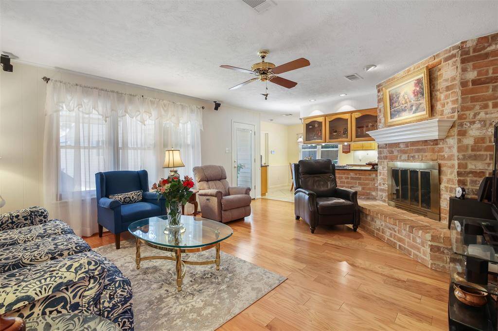 The family room has a gas log fireplace with brick surround with landing area and large mantle. There are also large picture windows over looking the backyard for plenty of natural light.