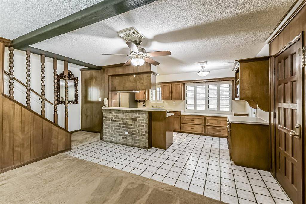 kitchen with breakfast bar and dry bar. Stairway to the left