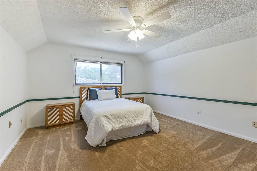 oversized secondary bedroom at top of stairs