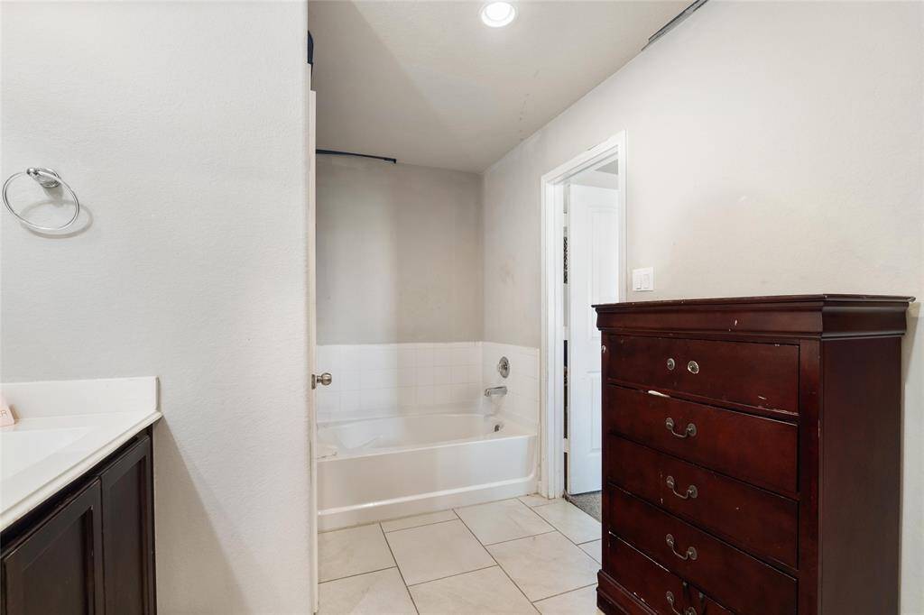 The primary bathroom includes a relaxing garden tub with tile surround, perfect for unwinding after a long day.
