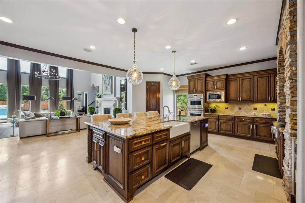 This photo beautifully captures the striking double-height ceiling, accented by exposed beams that add architectural charm. Also visible is the second-floor hall, offering a captivating overlook into the living space below, an element that enhances the open, airy feel of the home.