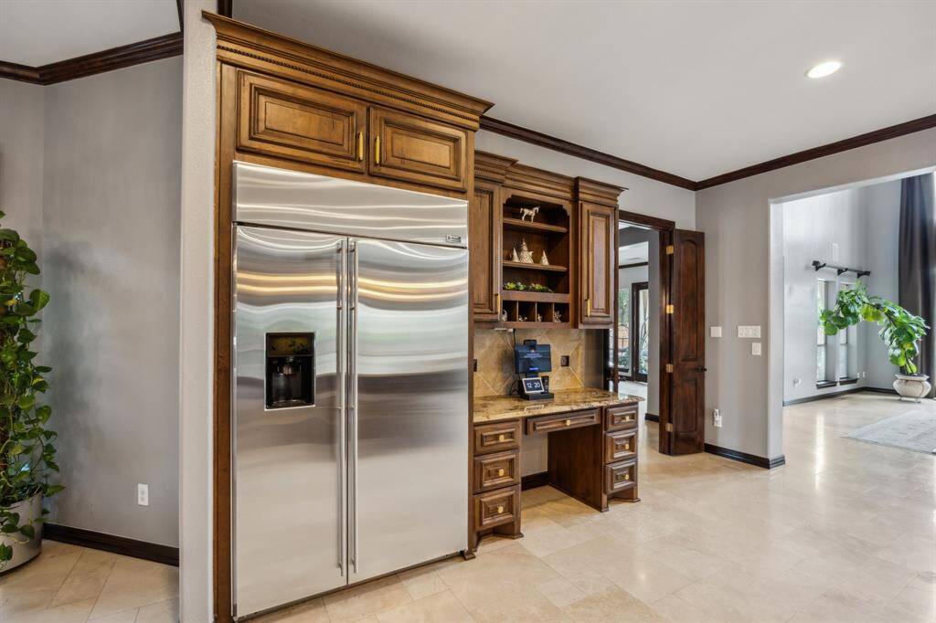 Bask in elegance with this charming Breakfast Nook that offers serene views of the courtyard. Perfect for family meals or coffee mornings, this space harmonizes sophistication with comfort. Note the Elegant Chandelier that, like the rest of the fixtures, is perfect for this showplace.