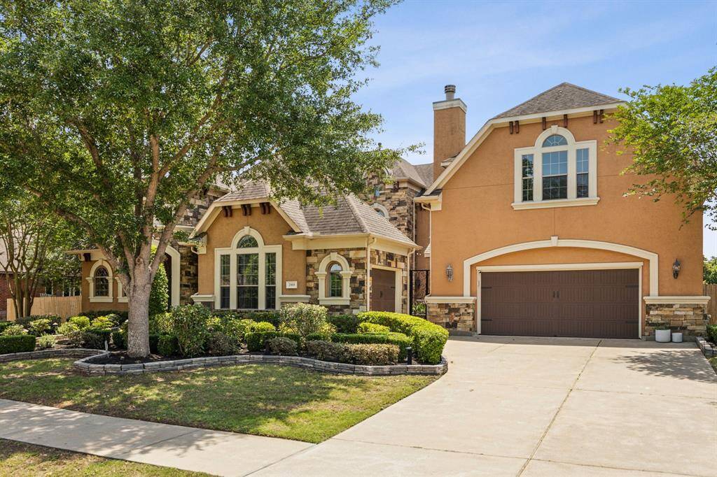 Welcome to your dream home, where elegance meets comfort! Doors and the lighting are charming showcased by the meticulous and lush landscaping.