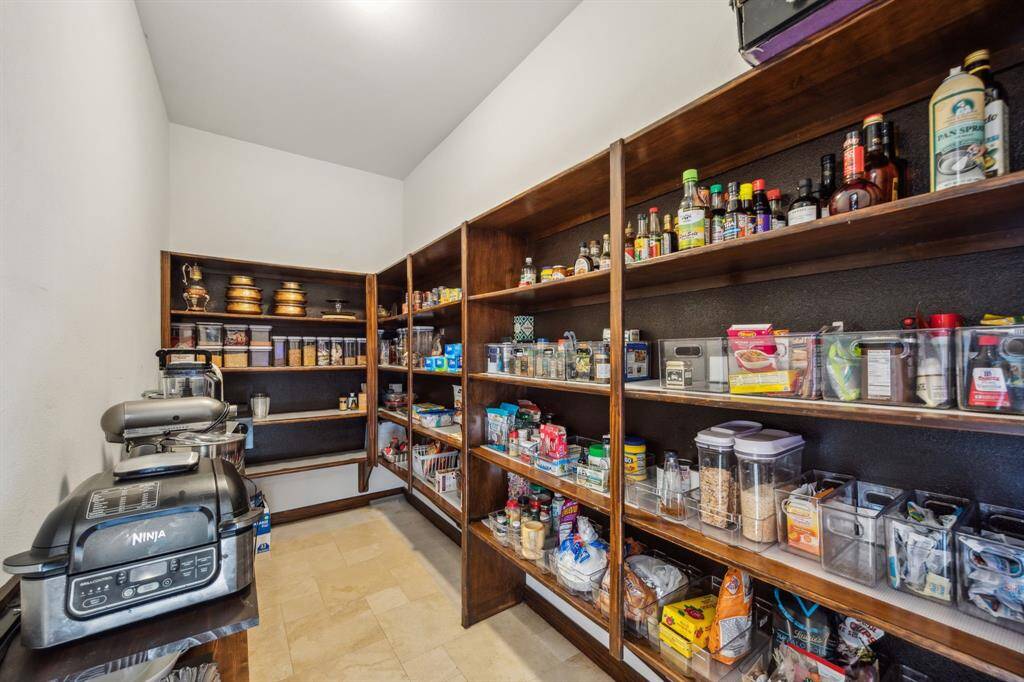 The Refrigerator is encased in the Gleaming Wood Cabinetry that elevates this home into a league of its own.