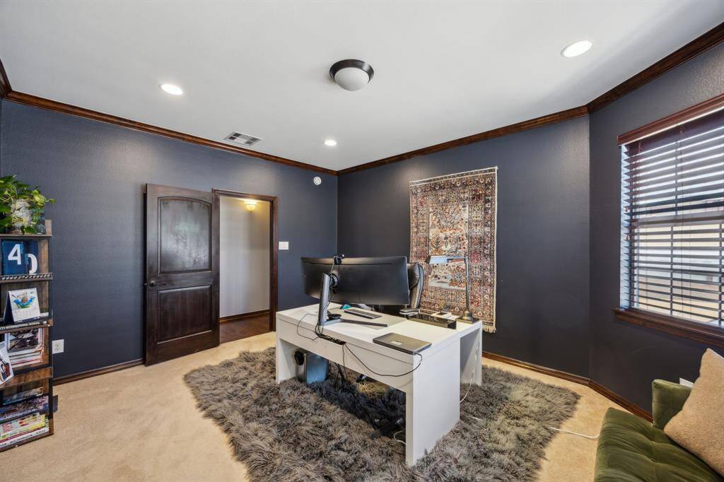 Indulge in luxury within this home's elegant bathroom, featuring custom cabinetry, perfect for starting your day with tranquility and sophistication.