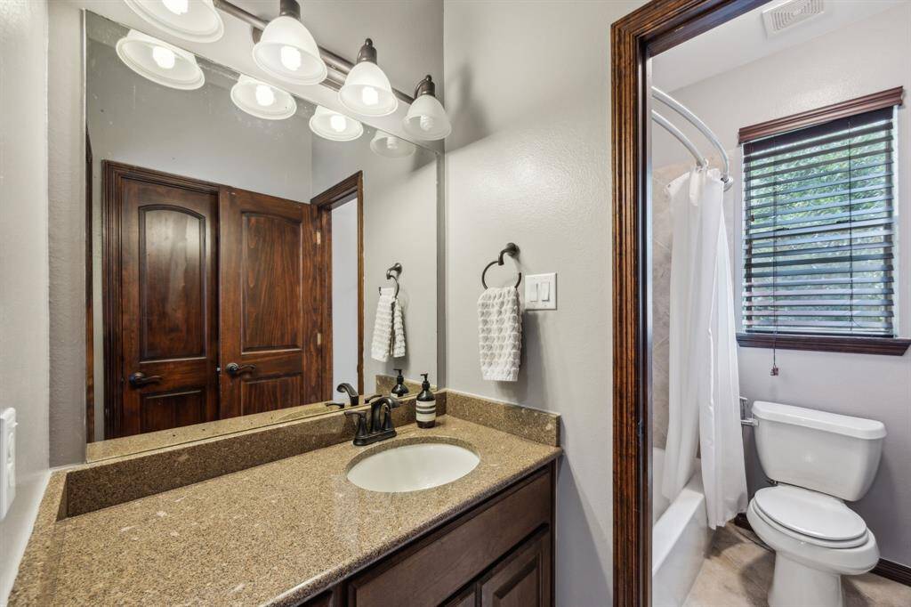 This sophisticated Fourth Bedroom space blends comfort and functionality perfectly, ideal for relaxation or productive home office days. The large windows bring in ample natural light, complemented by stylish details. There is an en-suite Full Bath as well as a large closet.