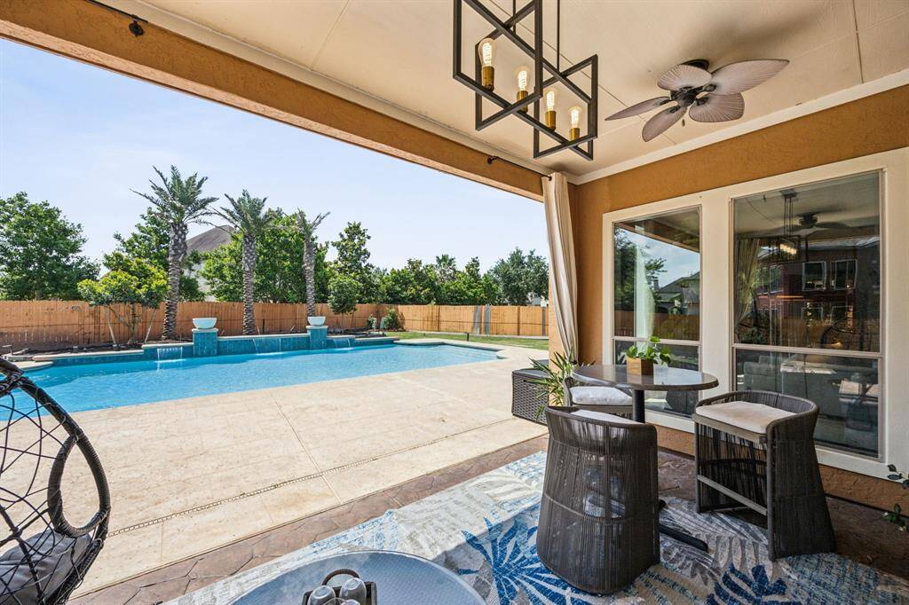 Experience effortless elegance with this stunning covered patio, your personal retreat! It's the perfect blend of luxury and comfort. Perfect for entertaining or a quiet night.