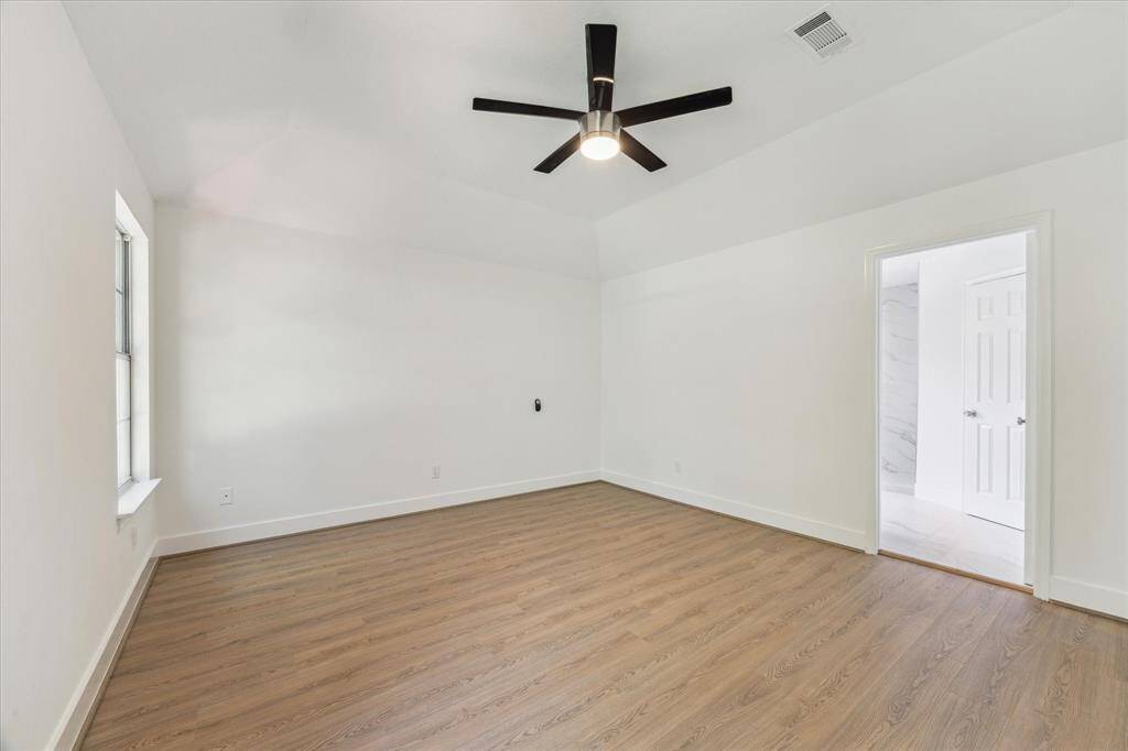 Another view of the master bedroom and views of the remodeled master bathroom.