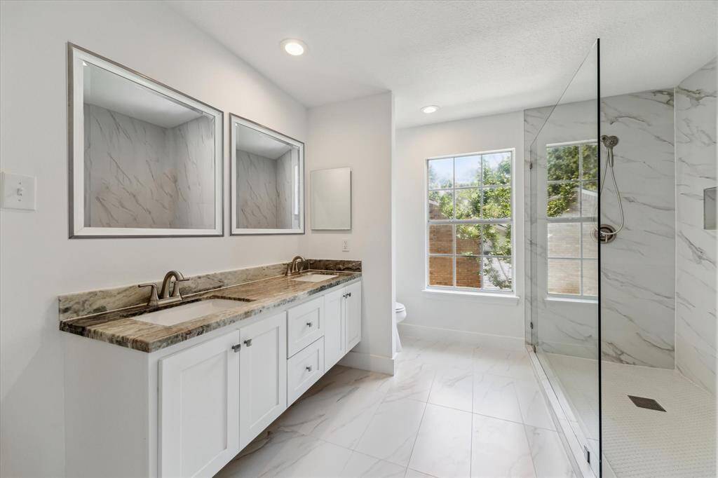 Remodeled from top to bottom, a spa like master bathroom. This master shower is just exquisite with the shower walls all the way up to the ceiling, an amazing glass window, the edge f the tile is done with all the detail that a master bathroom requires.