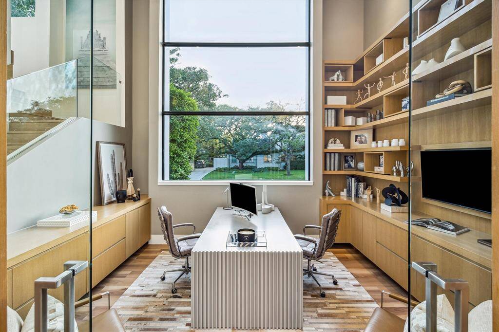 The study, featuring an impressive 18-foot ceiling and expansive windows, offers a serene and inspiring environment, an ideal setting for focused work or creative endeavors.