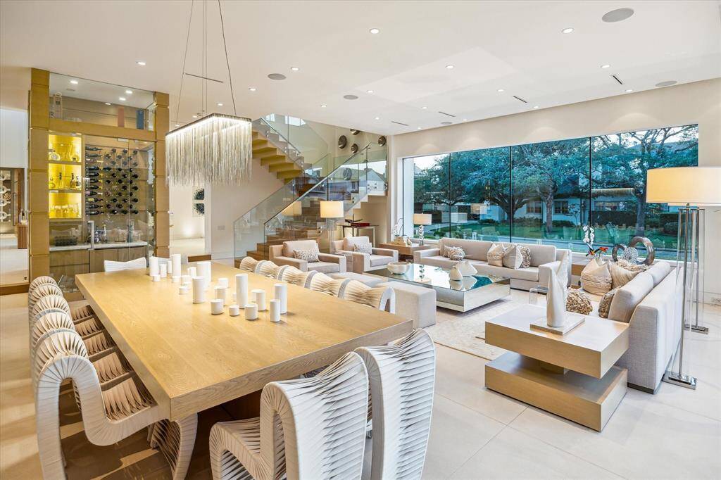 The expansive living room, ideally positioned with seamless access to the wine room and dining area, offers an elegant setting for both intimate family gatherings or grand-scale entertaining.