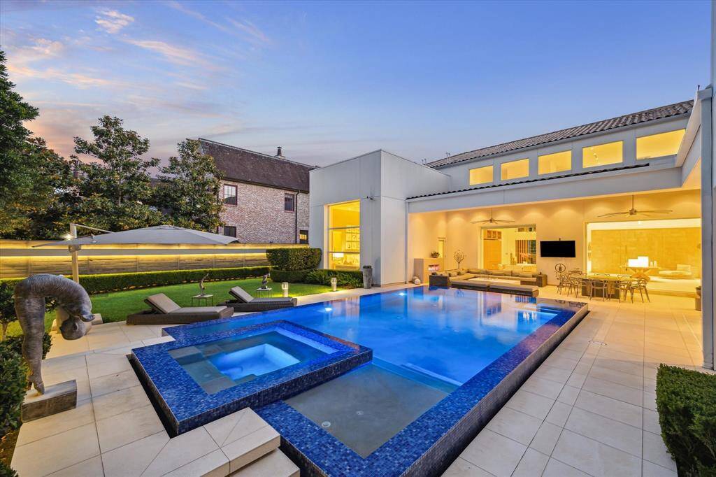 Discover your private oasis in this luxurious backyard, featuring an heated pool and spa with 360-degree infinity-edge and an expansive patio designed for ultimate relaxation.