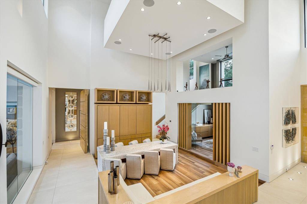 The reception hall features a dramatic 24-foot ceiling and expansive windows.