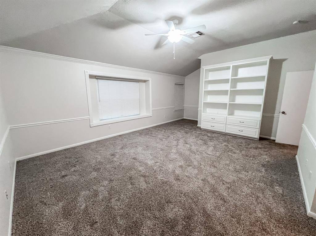 Built in shelves and cabinets in the oversized primary bedroom.
