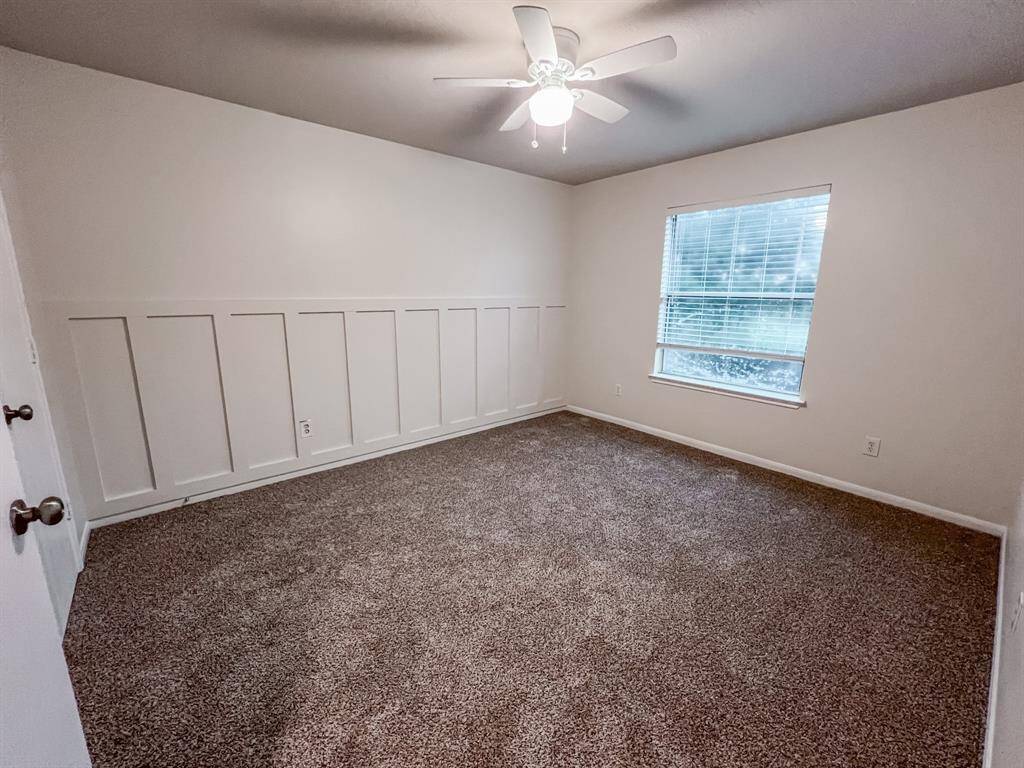Third bedroom has beautiful board and batten accent wall and a large walk-in closet.