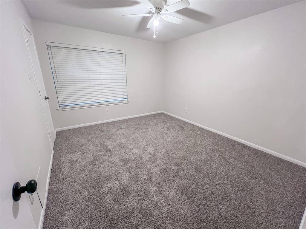 Fourth bedroom looks out to the front yard and has a large walk-in closet.