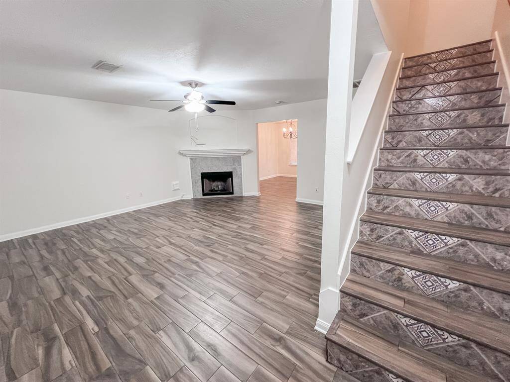 The staircase has decorative tile that welcomes guests as they enter the home.