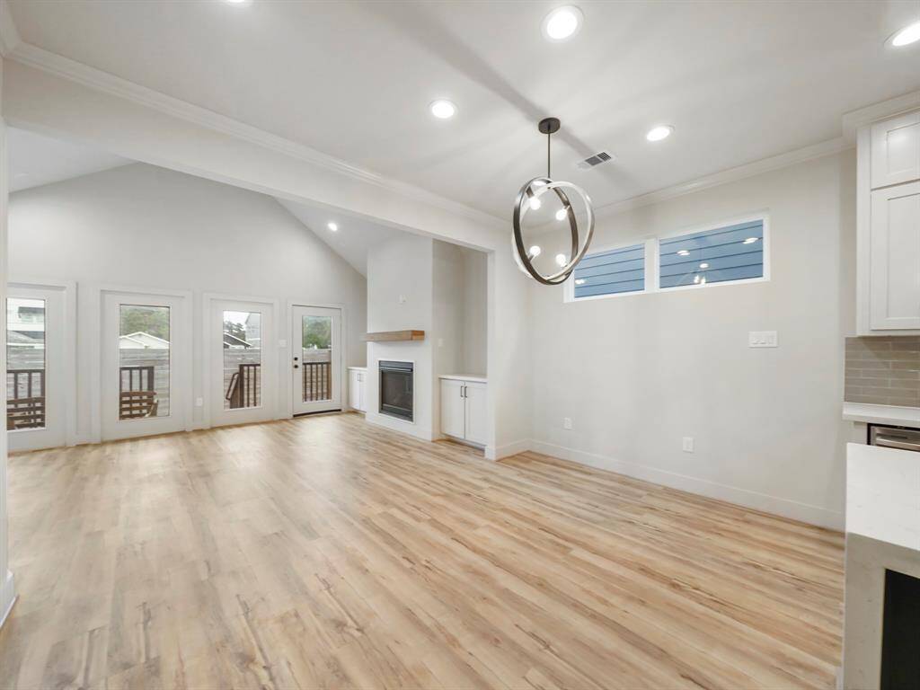The kitchen, dining room and living room seamlessly flow with beautiful vinyl plank flooring connecting all the spaces.