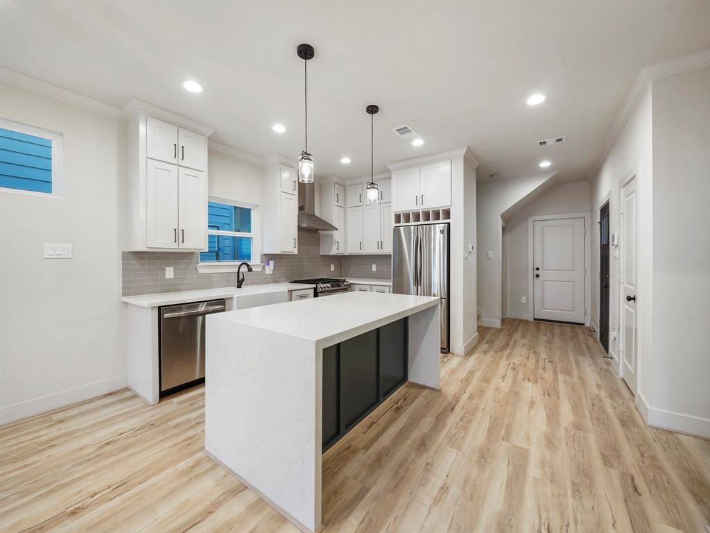 This kitchen boasts sleek stainless steel appliances, including a refrigerator for all your storage needs. But that's not all – tucked neatly into the stunning waterfall island is a convenient microwave, adding both functionality and style to your cooking space. Prepare meals with ease, entertain guests, and enjoy the seamless integration of style and convenience in your new kitchen. Welcome to a space where cooking becomes a joyous experience.