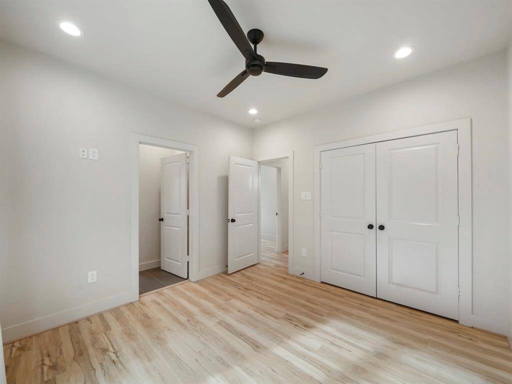 Spacious secondary bedroom with ceiling fan and large closet.