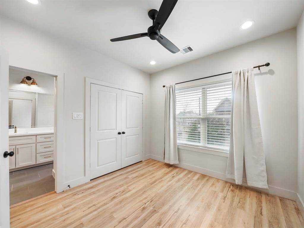 Third bedroom with ceiling fan and spacious closet.