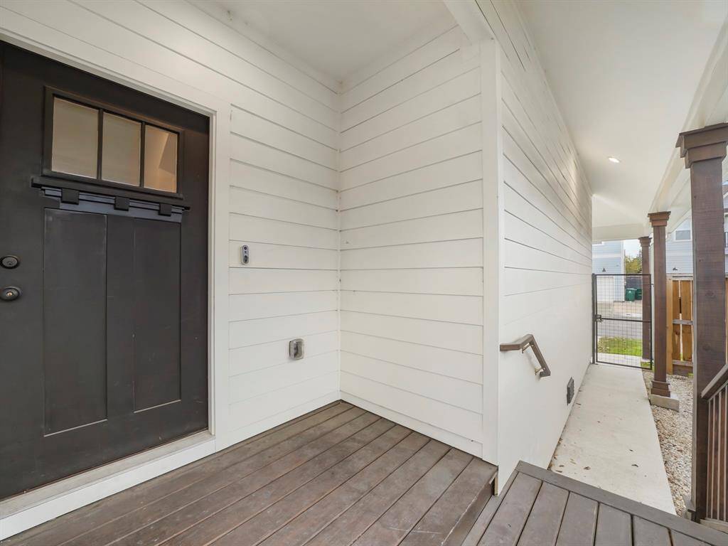 The privacy gate leads to a covered walkway leading to the front door and porch.