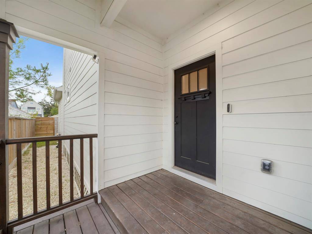 Beautiful craftsman style door, covered porch with video doorbell.
