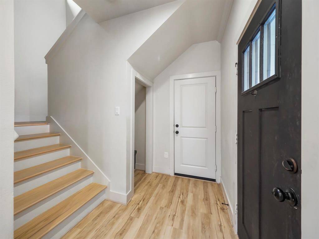 Step into the front entrance of this charming home, where convenience and practicality intersect seamlessly. This photo captures a distinct doorway leading directly to the garage, offering easy access for your vehicles and storage needs. With this separate entrance, you have the flexibility to come and go with ease, whether it's unloading groceries or heading out for the day.