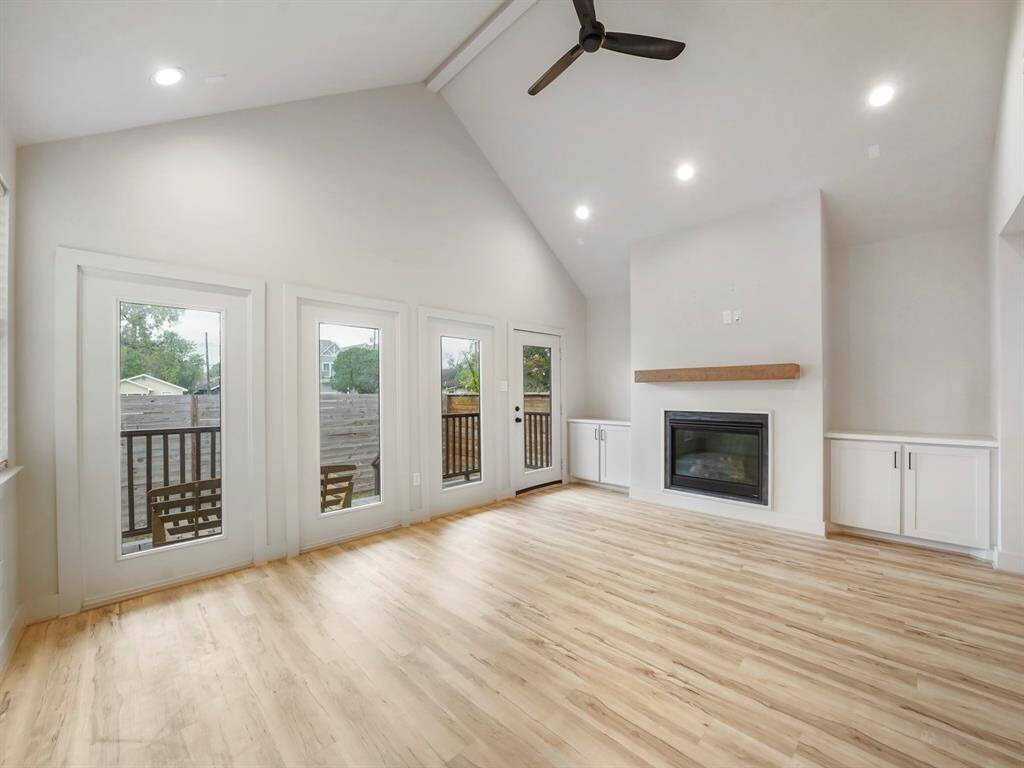 Step into your inviting living room retreat! With a vaulted ceiling adding grandeur, a cozy fireplace with a mantle, and custom cabinetry providing both style and storage, this space is perfect for relaxation. Large windows offer views of the serene back porch, creating a tranquil atmosphere for unwinding and making memories.