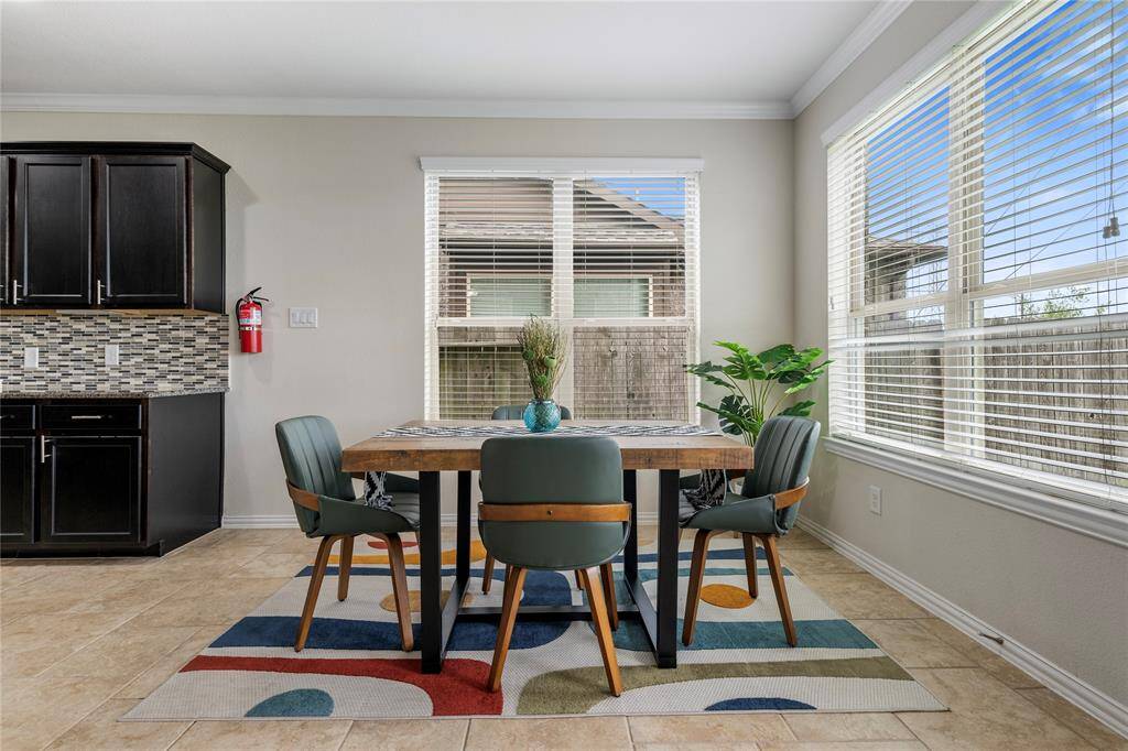 The formal dining area offers an elegant space for hosting dinners, with easy access to both the kitchen and living areas.