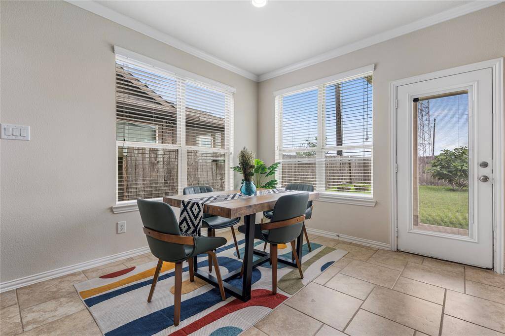 The formal dining area offers an elegant space for hosting dinners, with easy access to both the kitchen and living areas.