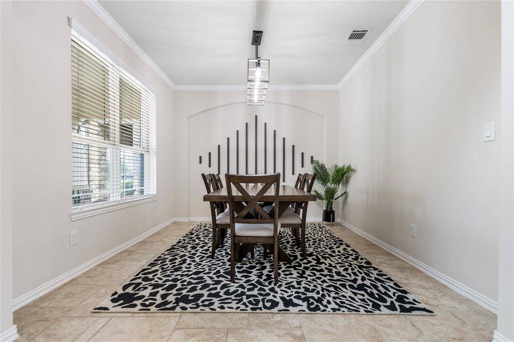The formal dining area offers an elegant space for hosting dinners, with easy access to both the kitchen and living areas.