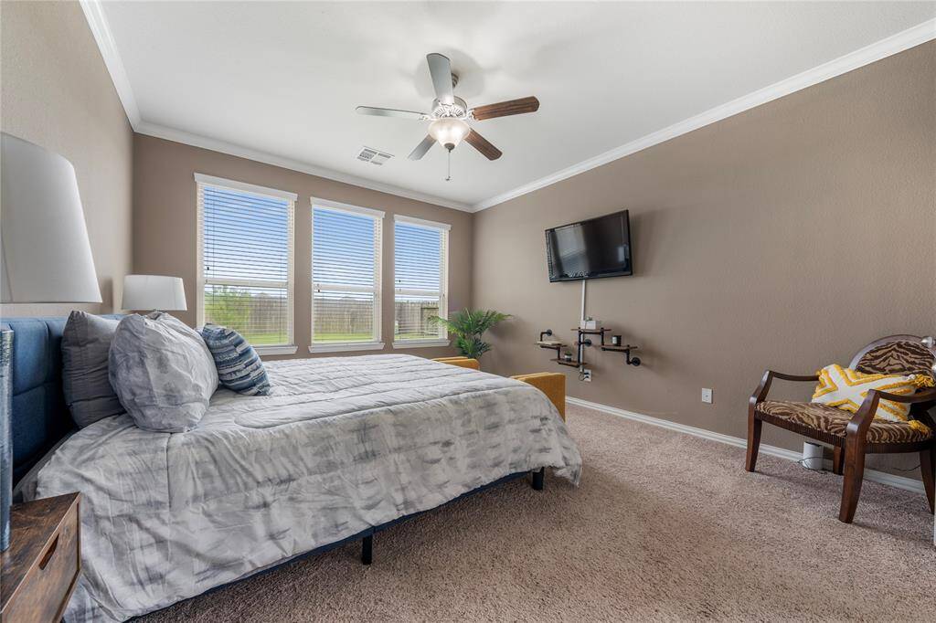 Located on the first floor, the oversized primary bedroom serves as a private retreat, featuring a luxurious en-suite bathroom with a soaking tub, dual vanities, and a separate shower.