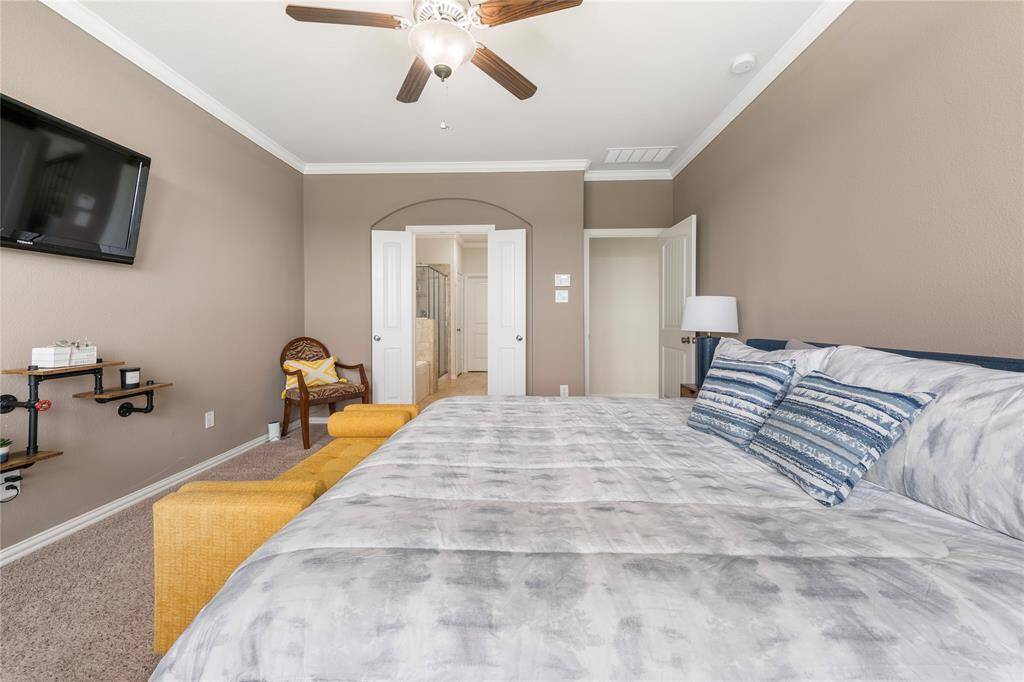 Located on the first floor, the oversized primary bedroom serves as a private retreat, featuring a luxurious en-suite bathroom with a soaking tub, dual vanities, and a separate shower.