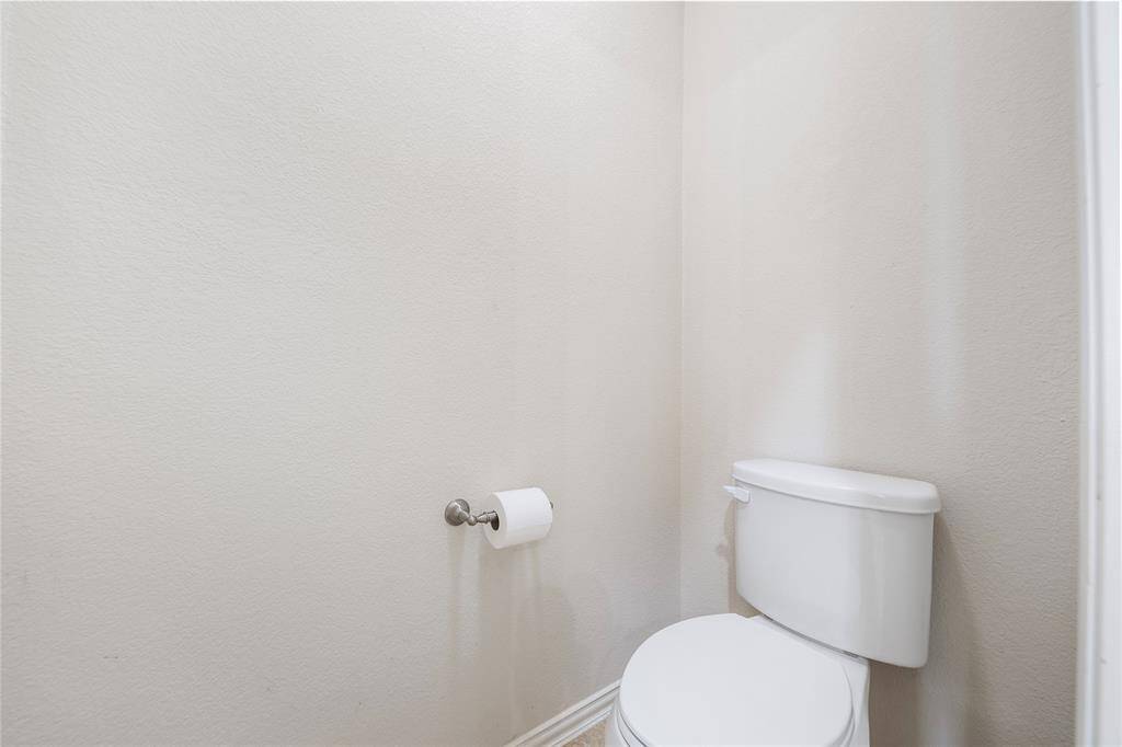 Located on the first floor, the oversized primary bedroom serves as a private retreat, featuring a luxurious en-suite bathroom with a soaking tub, dual vanities, and a separate shower.