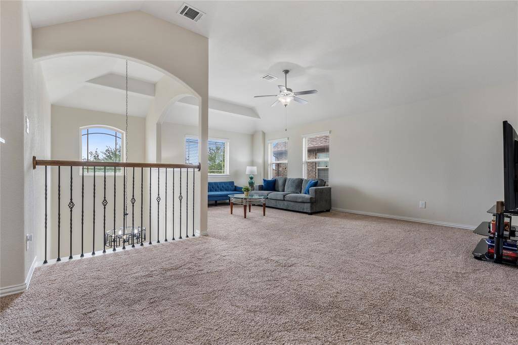 Upstairs, you'll find three generously sized bedrooms, each with ample closet space, sharing access to well-appointed bathrooms.