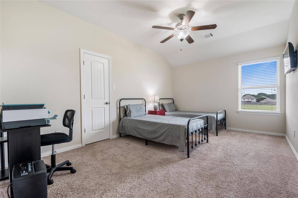 Upstairs, you'll find three generously sized bedrooms, each with ample closet space, sharing access to well-appointed bathrooms.