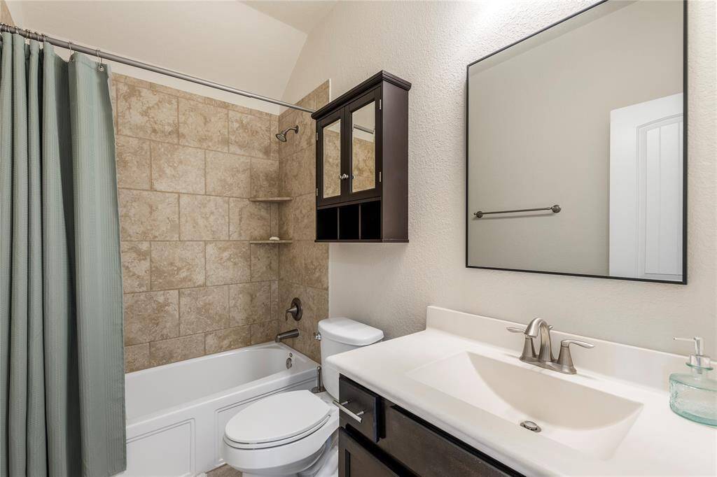 Upstairs, you'll find three generously sized bedrooms, each with ample closet space, sharing access to well-appointed bathrooms.