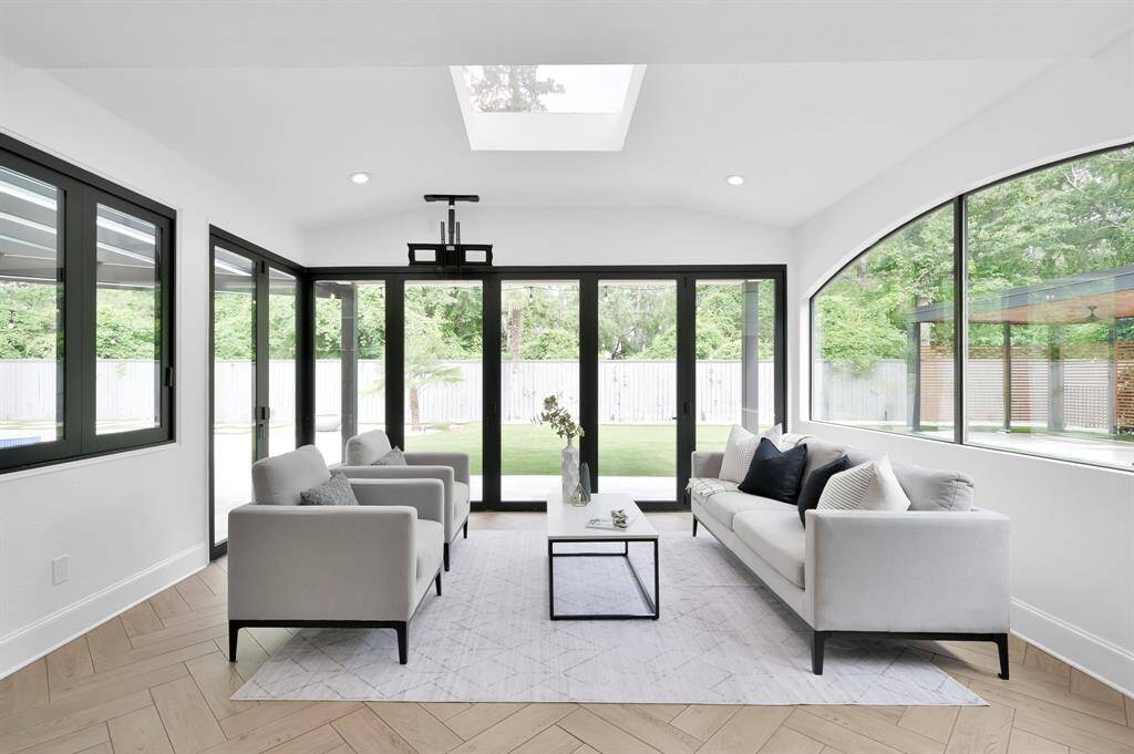 Windows in sunroom are a series of accordion folding doors and can be opened completely to bring the outdoors in.