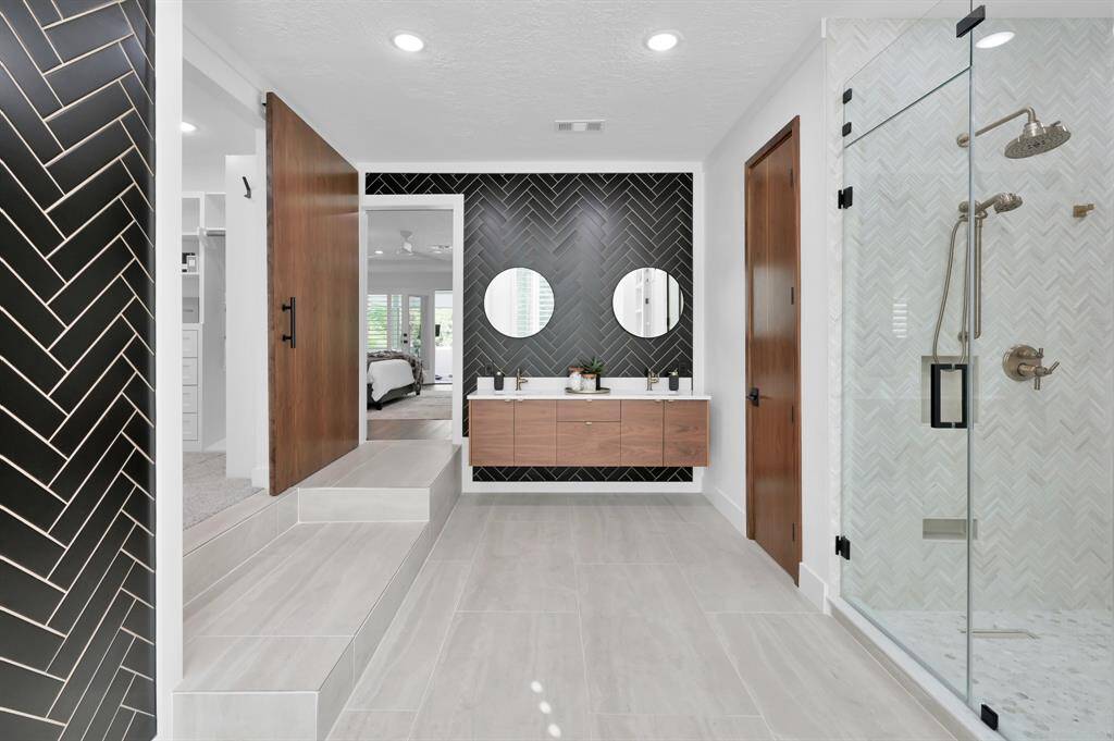 The primary bedroom is a true retreat, complete with its own fireplace, enclosed balcony, modern en-suite bathroom with custom closet.