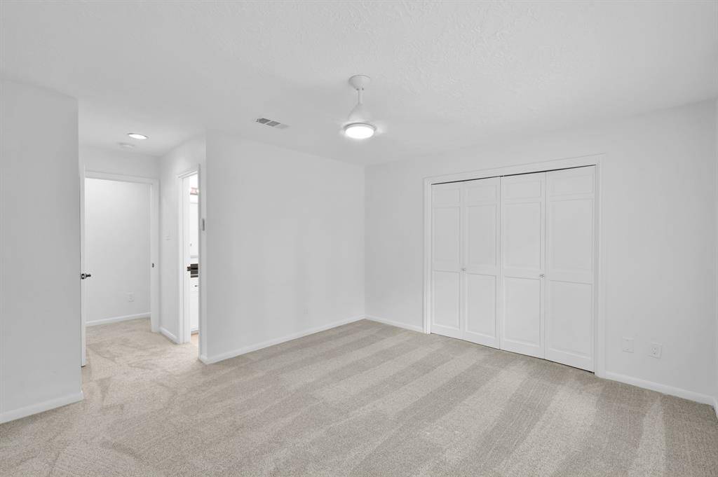 The exquisite custom closet with sliding door acts as a private dressing room.