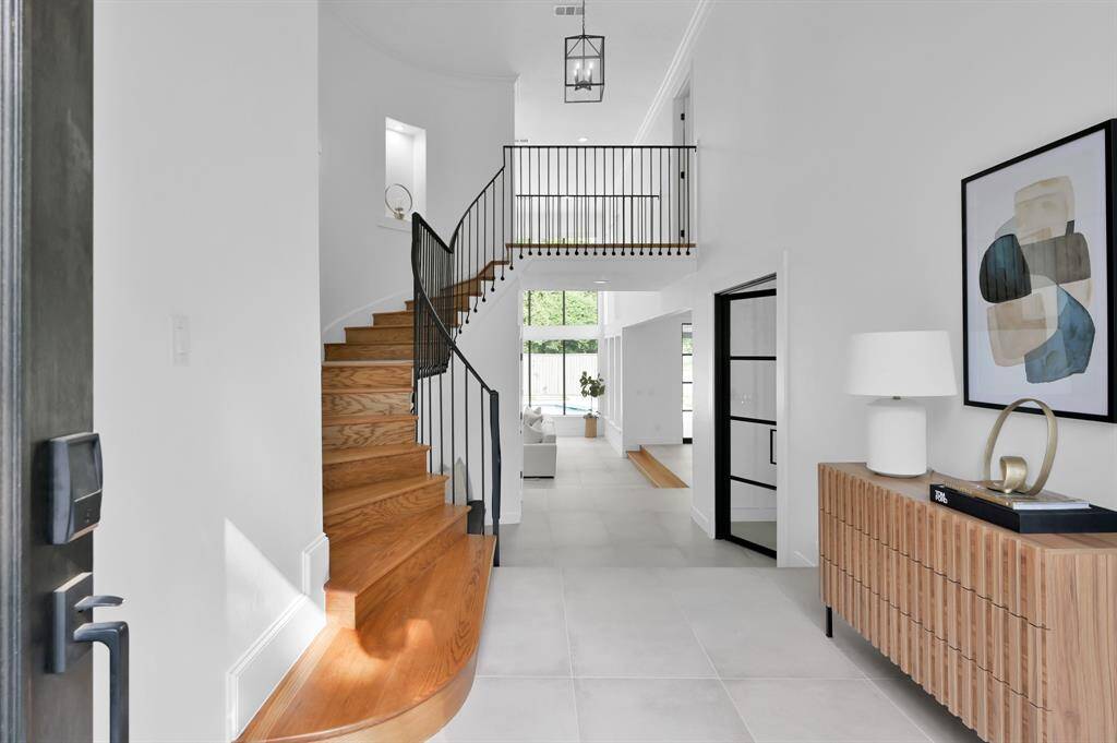 Multi level luxury greets you at the front entrance. The elegant iron doors on the right enter the private office.