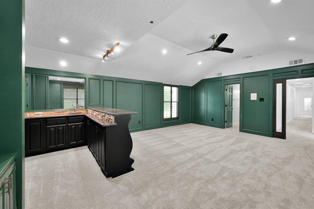 Custom shutters and a unique closet in bedroom 4 with a upper cabinetry cabinet and large drawers for storage.