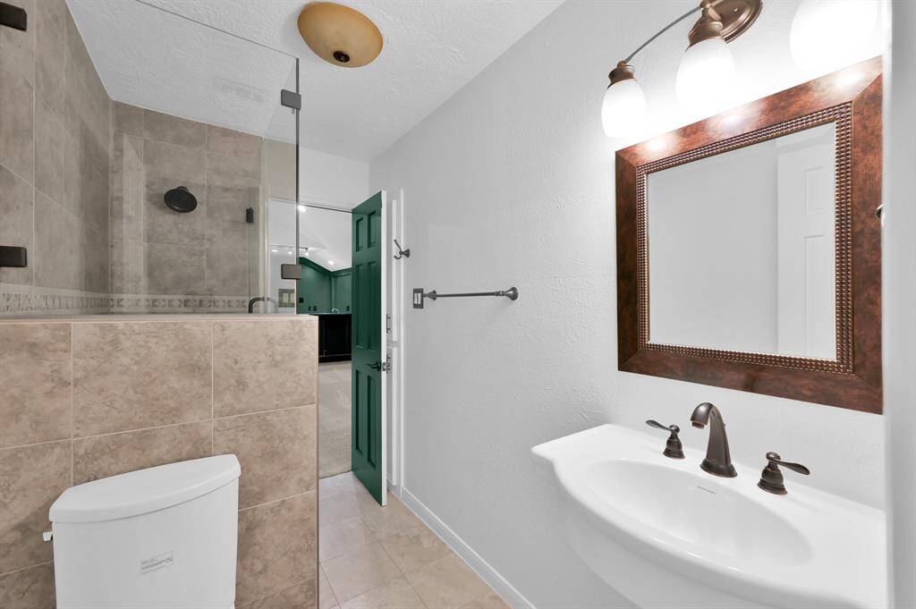 Extra large game room with walk-in attic located behind the wet bar.