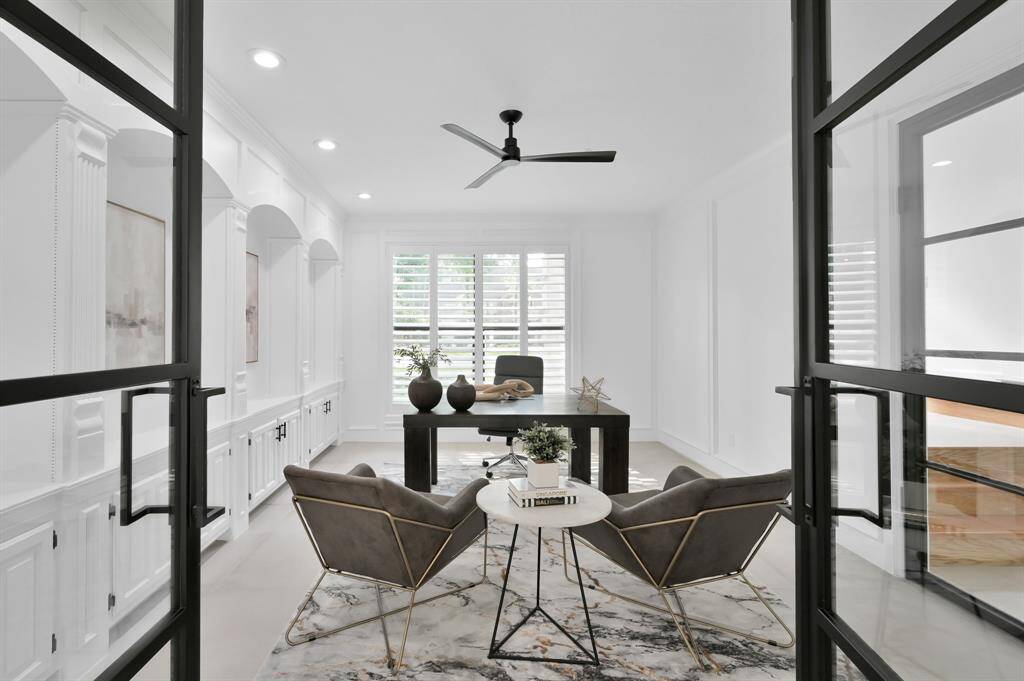 The private office includes two sets of iron glass doors, one set opens to the formal dining area, the other set opens to the grand foyer.