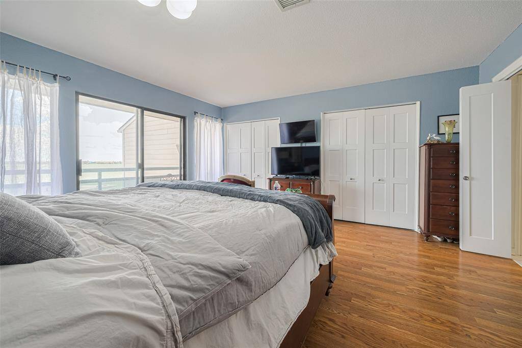 Primary bedroom has amazing wall to wall windows with views of the lake)