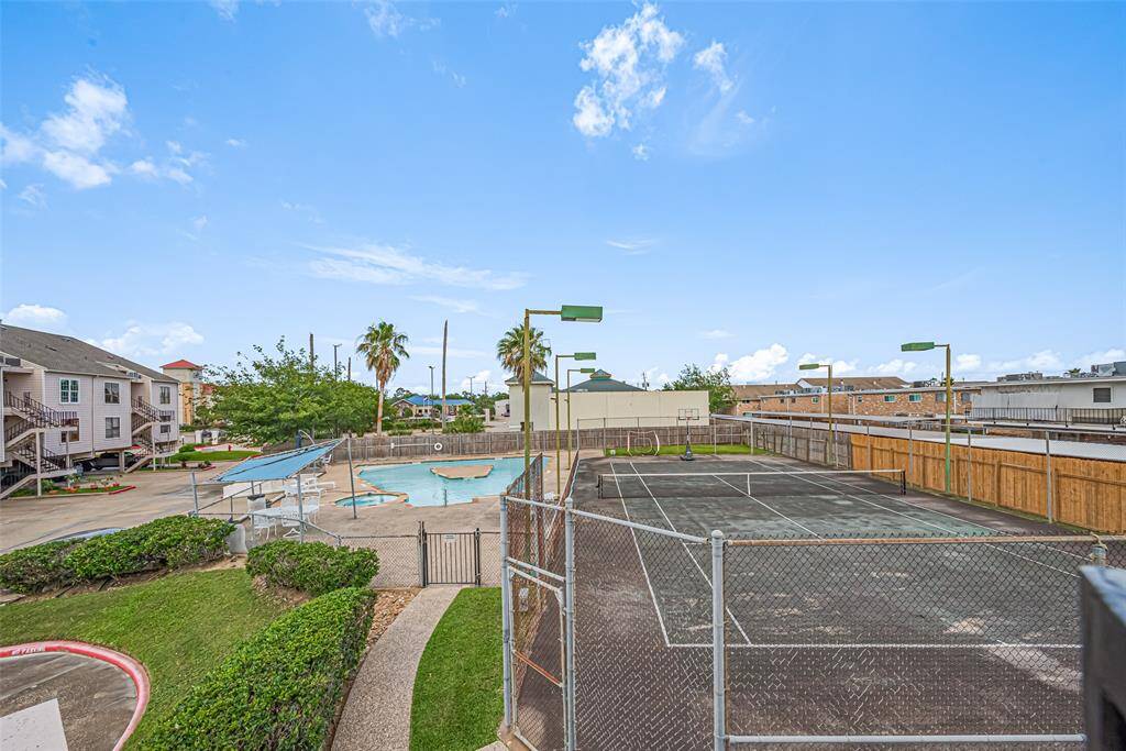 View from front door balcony of pool and tennis court